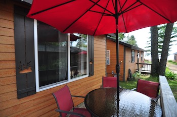 deck of cottage #1 with red umbrella covered patio table